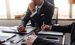 Two business individuals sitting together at a table